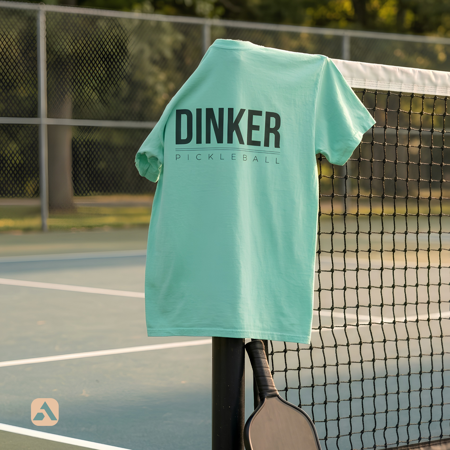 Dinker pickleball t-shirt, Island Reef — draped over the net